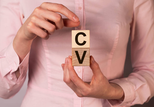 CV acronym on wooden cubes in HR hands. - Φωτογραφία, εικόνα