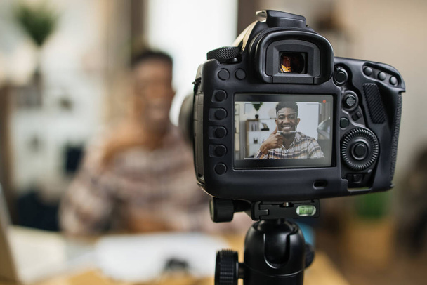 Black man recording video tutorial on camera at home - Foto, afbeelding