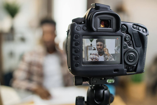 African man in headset recording online lesson on camera - Valokuva, kuva
