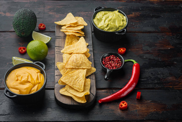 Mexican nachos with sauce set, on old wooden table with copy space for text - Foto, imagen