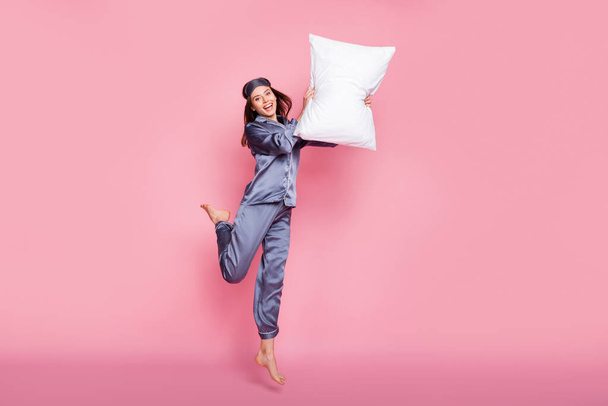 Full length body size photo of girl in sleepwear laughing fighting with pillow on pajama party isolated on pastel pink color background - Fotoğraf, Görsel