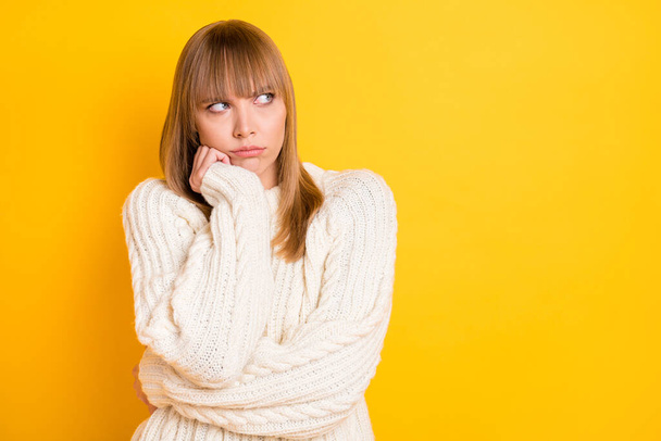 Portrait of unsatisfied sullen lady hand on cheek look empty space wear warm pullover isolated on yellow color background - Foto, Bild