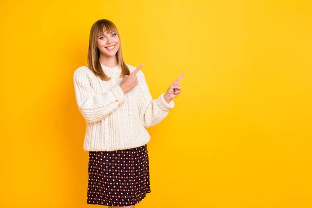 Photo of charming person indicate fingers empty space toothy smile wear sweater isolated on yellow color background - Valokuva, kuva
