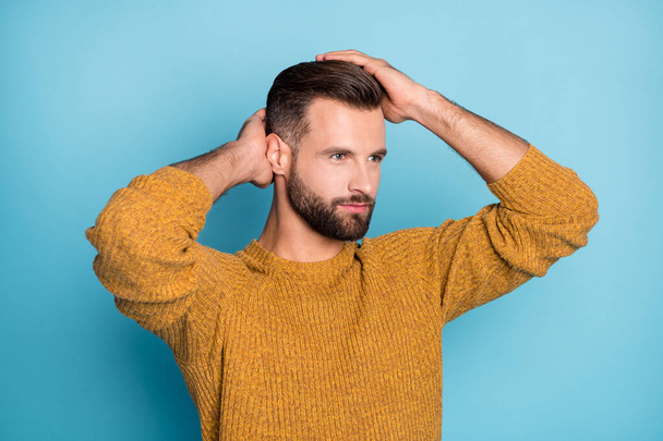 Photo of young handsome positive handsome man look copyspace fixing hairstyle isolated on blue color background - Photo, Image