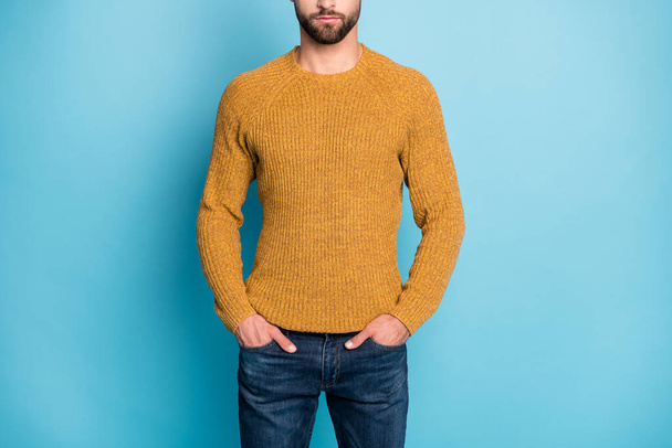 Cropped photo of young serious confident businessman hold hands in pockets wear knitted sweater isolated on blue color background - Valokuva, kuva
