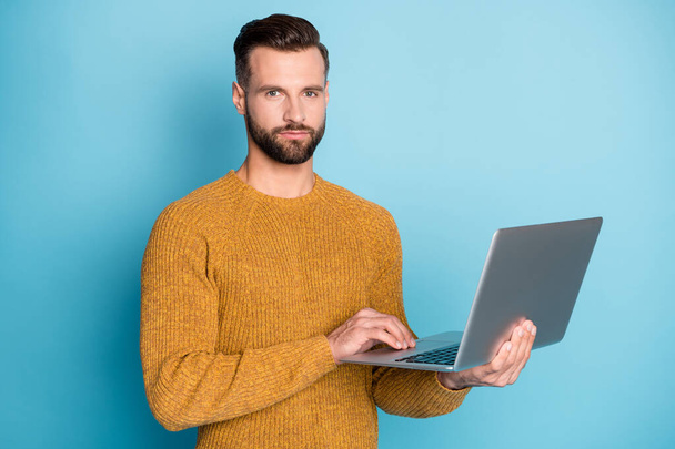 Portrait of nice attractive serious content guy holding in hands using laptop copywriter isolated over bright blue color background - Фото, изображение
