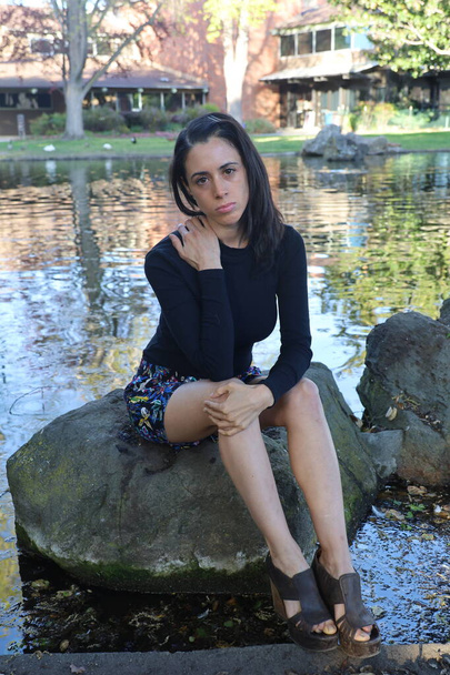 Photoshoot of a Hispanic model in a park - Photo, Image