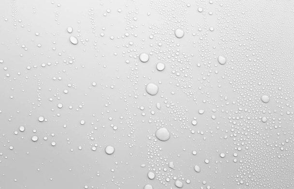 gota de agua en la superficie blanca como fondo - Foto, Imagen