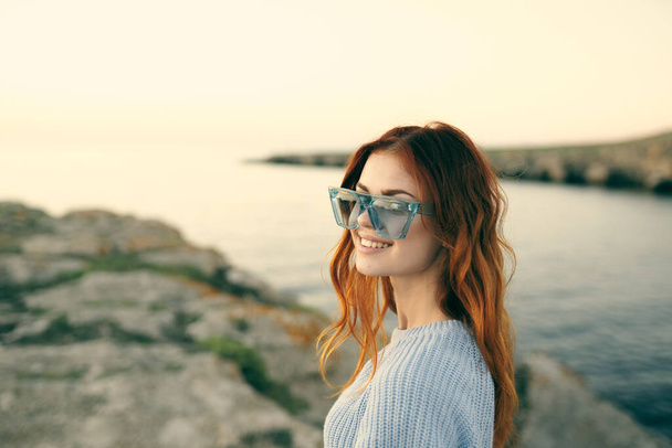 cheerful woman with glasses outdoors landscape island travel - Zdjęcie, obraz