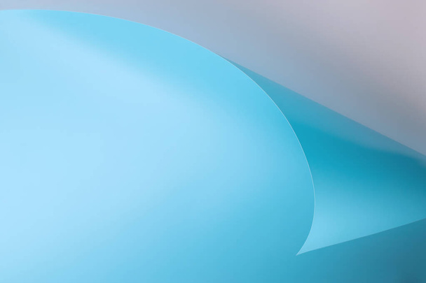 una hoja de papel azul con una esquina curva sobre un fondo gris - Foto, Imagen