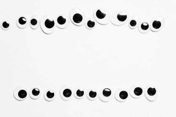 Parallel lines from toy eyes on white background - Photo, Image