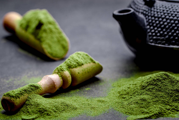 Powdered green tea and set for matcha on black background - Photo, Image