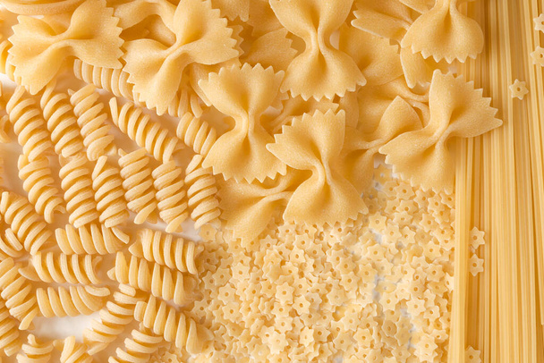 Types of Italian pasta: fusilli, farfalle, fettuccine, spaghetti, stars. - Photo, Image