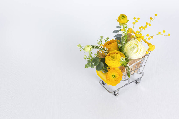 flowers in mini cart, white background - 写真・画像