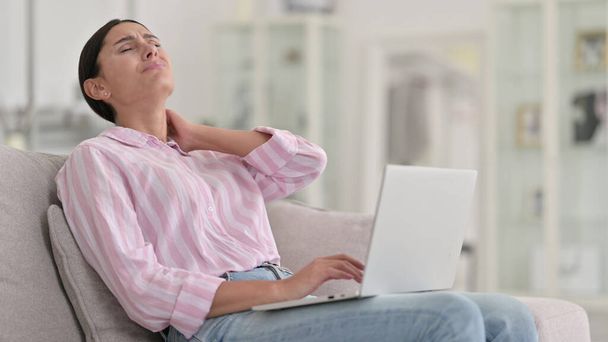 Tired Young Latin Woman with Laptop having Neck Pain at Home  - Fotoğraf, Görsel
