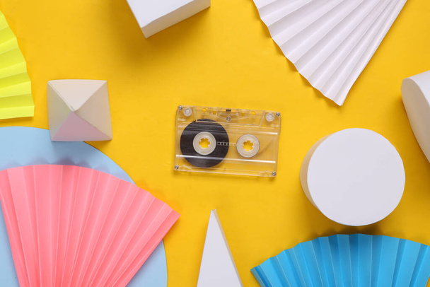 Audio cassette on yellow abstract background with geometric shapes. Minimalism. Concept art. Creative layout - Foto, afbeelding