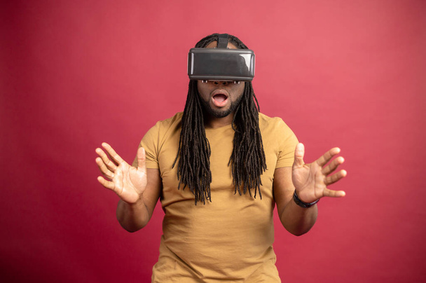 Young African American guy wearing VR headset - Foto, Bild