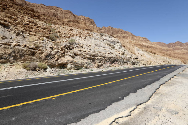 Cesta podél pobřeží Mrtvého moře v Judejské poušti v jižním Izraeli. Horký slunečný den.  - Fotografie, Obrázek