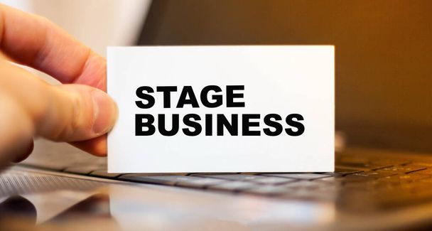 STAGE BUSINESS in the hands of a businessman on the background of a laptop - Photo, Image