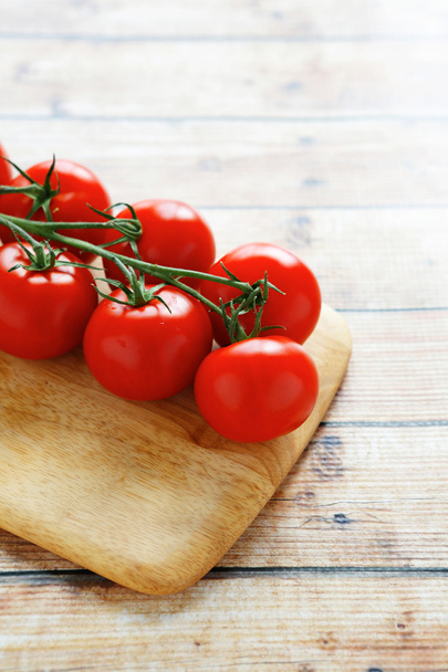 fresh tomatoes on a branch - Фото, изображение