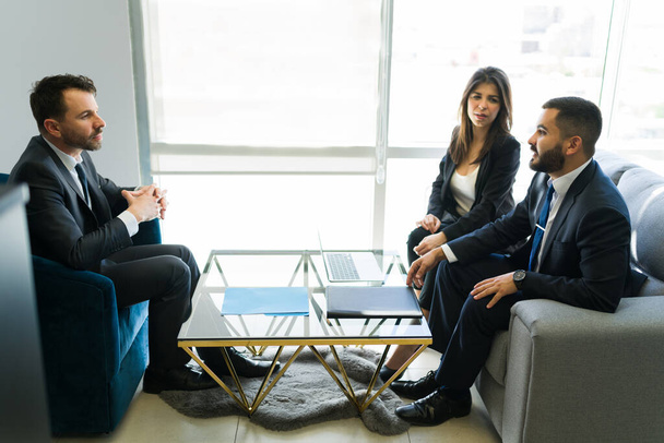 Successful business partners offering their services to a company executive. Two sales representative trying to make a sales deal during a meeting - Photo, Image
