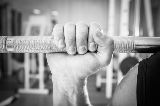 Hand holding barbell - Foto, afbeelding