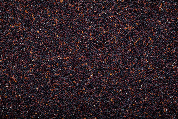Peruvian seeds black quinoa, close-up. Top view. Cereal contains a large array of proteins, antioxidants, dietary fibers, vitamins and mineral key to healthy diet. - Foto, Imagen