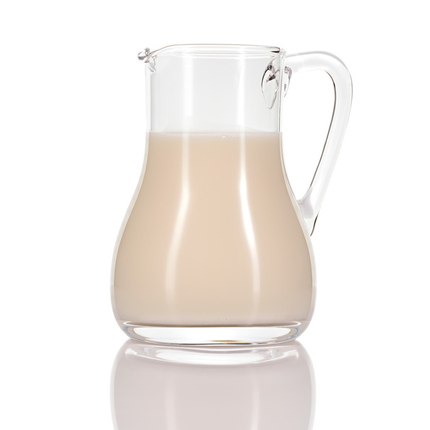 Almond milk in jug on white background. - Photo, Image