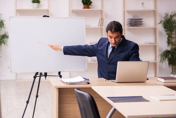 Young male employer in front of white board - Photo, Image