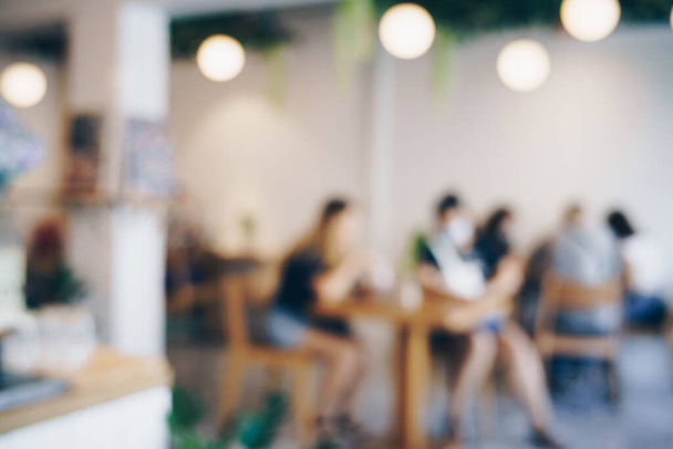 Abstract wazig mensen zitten in cafe restaurant met lichte gezellige winkel zakelijke achtergrond - Foto, afbeelding