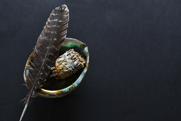 A top view image of a spiritual smudge kit on a black background.  - 写真・画像