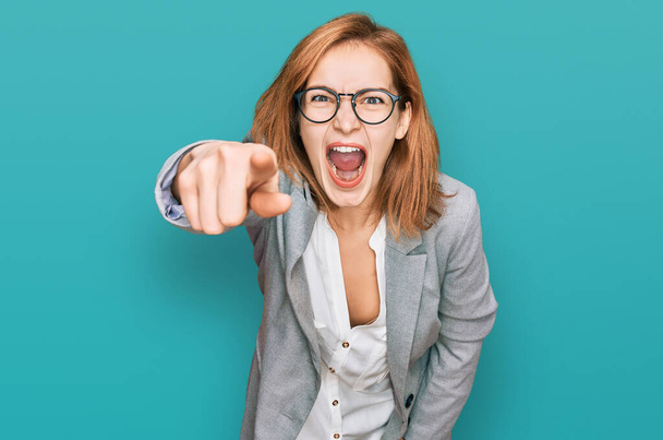 Young caucasian woman wearing business style and glasses pointing displeased and frustrated to the camera, angry and furious with you  - Foto, afbeelding