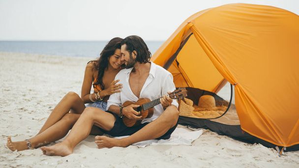 Romantic Couple Near a Tent on the Beach - Foto, afbeelding