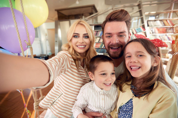 A happy family having a fun while taking a selfie in a cheerful atmosphere at home together. Family, leisure, together - Zdjęcie, obraz
