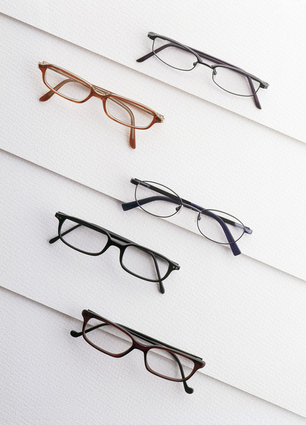 Eyeglasses over a white textured background  - Foto, Bild