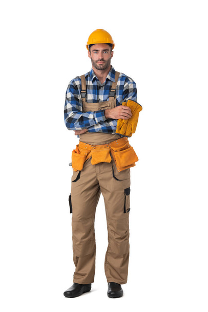 Contractor worker in coveralls and hardhat standing with arms crossed isolated on white background, full length portrait - Foto, immagini