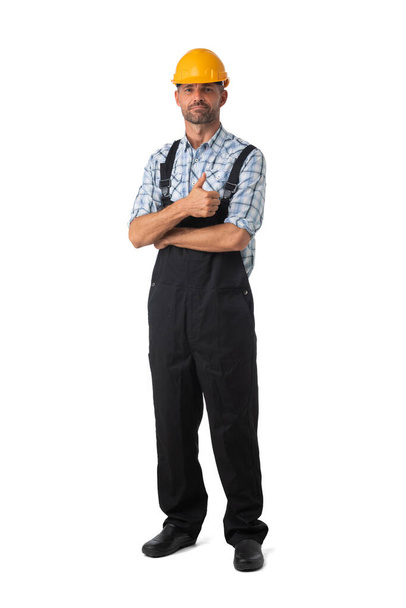 Full length portrait of confident male repairman contractor worker in coveralls with thumb up on white background - Valokuva, kuva