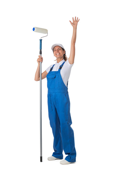 Female house painter with paint roller raised arms isolated on white background full length studio portrait - Foto, Imagen