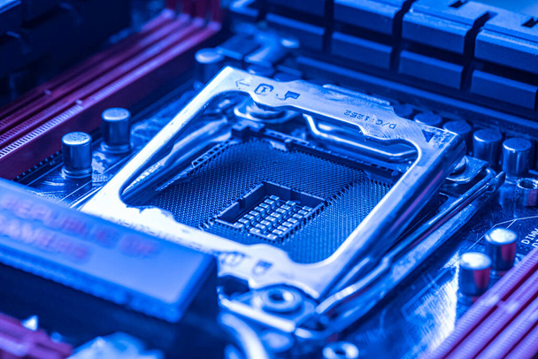 LOS ANGELES, USA 25 APRIL 2021: Detail of a Cpu socket in a motherboard of a gaming pc in bluie light - Фото, зображення