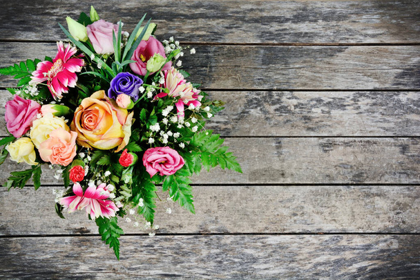 Bouquet of different colorful flowers on an old wood table - Photo, Image