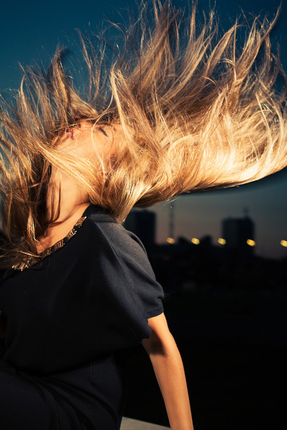 Attractive blonde with hair flying on the wind - Фото, зображення