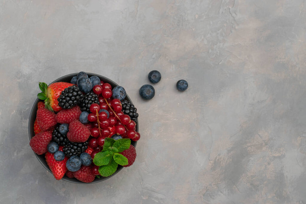 Ripe sweet different berries in bowl. Close up, top view, high resolution product. Harvest Concept - Photo, Image