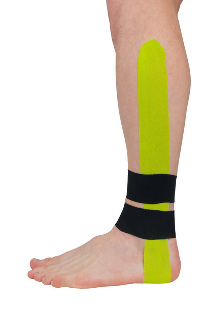 a fixing tape is pasted on the ankle, for pain in the joints and muscles - Photo, image