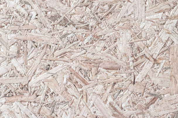 Чіпборд, OSB - орієнтована частинка нитки, пресована на перероблений дерев'яний фон панелі з сірим дерев'яним волокном фону візерунка природного бежево-коричневого кольору
 - Фото, зображення