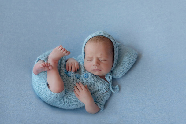Newborn baby boy in a blue knitted hat. - Photo, Image