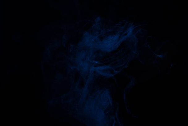 Blue and pink steam on a black background. Copy space. - 写真・画像