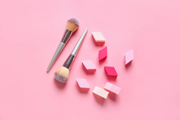 Makeup sponges with brushes on color background - Photo, Image