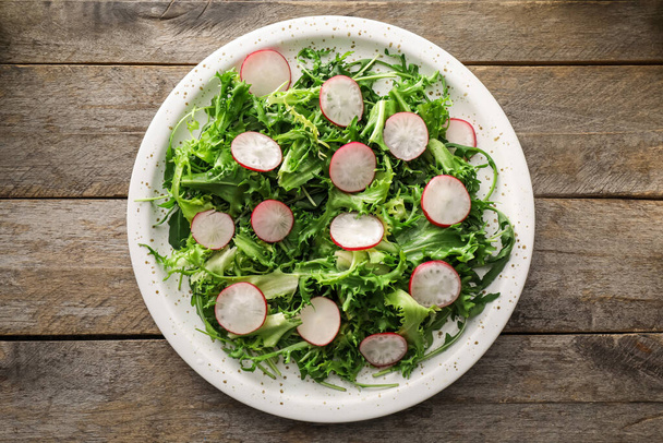 Placa de sabrosa ensalada con verduras frescas sobre fondo de madera - Foto, Imagen
