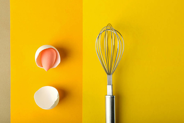 Creative composition with makeup sponge and whisk on color background - Photo, Image
