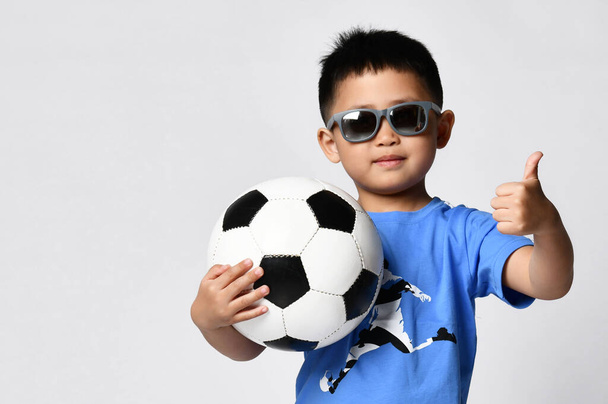 Young little boy with soccer ball gesturing thumbs up for camera - Φωτογραφία, εικόνα